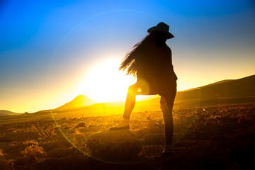 A beautiful woman silhouette at sunset