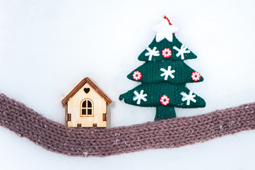 Toy house with a Christmas tree in the snow.,  Christmas, New Year congratulations.