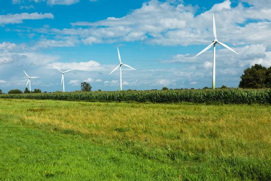 wind turbine surrounded by green fields