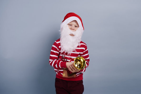 Child wearing santa hat and beard.