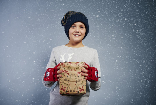 Front view of boy with christmas gift