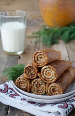 Russian pancakes with dill wrapped in rolls