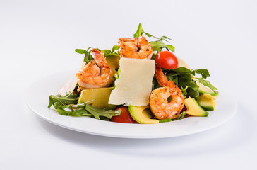 Fresh dietary salad with shrimps, ruccola, cherry tomatoes and Parmesan cheese. (Light background and close)