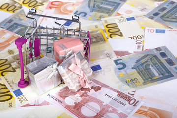 Euro Banknotes with Shopping Cart and Gift Boxes Consuming Concept
