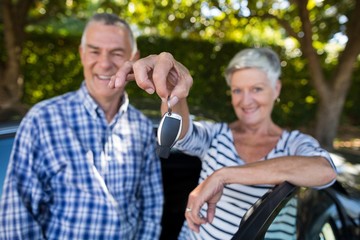 Senior couple showing car keys