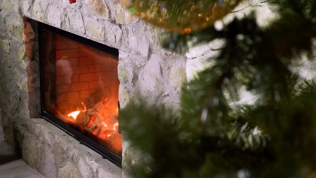 Close-up shot of warm cozy burning fire in a brick fireplace. 4K