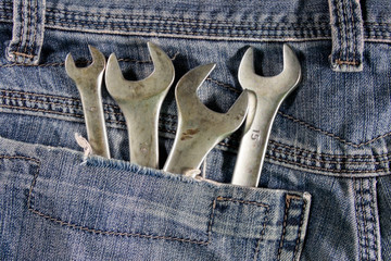 Wrench tools in the pocket of blue jeans