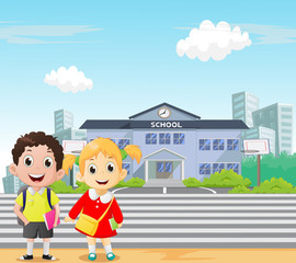 Happy school children standing in front of school. back to school concept