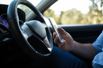 Man using mobile phone in car