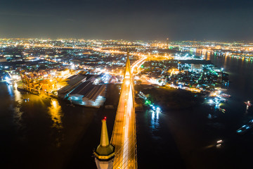 Aerial top view night traffic bridge river side with city