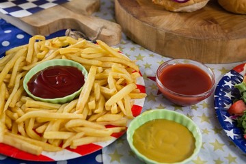 French fries on wooden table with 4th july theme