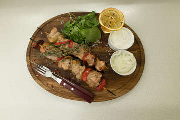 Delicious barbecued ribs seasoned with a spicy basting sauce and served with chopped fresh...