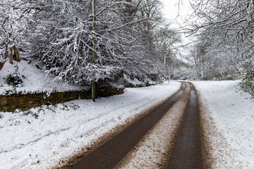 Snow covered road through a small village
