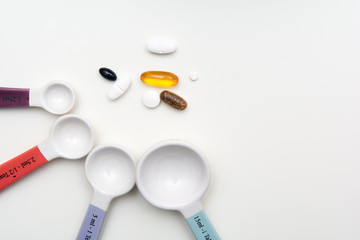 Medicine pills and tablets with spoons to measure medicine dose. Medical background