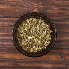 Green paprika spice in a bowl on a wooden background