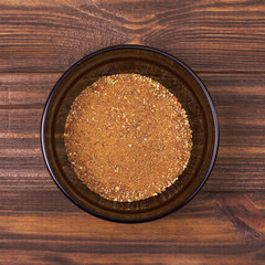 Peppers mix powder in a bowl on a wooden background