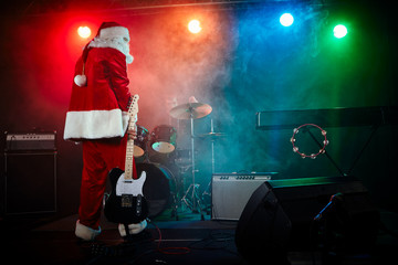 Santa Claus plays rock.