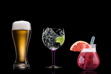 Selection of cocktails martini spritz bramble gin tonic beer bramble bar blurred black background