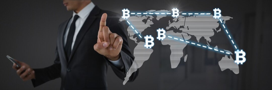 Businessman touching bitcoin graphic icons on world map