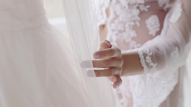 The bride wears a wedding dress in the morning