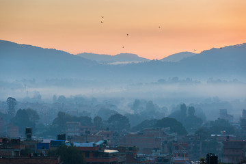 View of Bhaktapur, Nepal at sunrise with Himalaya mountains in background.