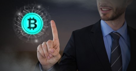 Businessman touching bitcoin graphic icon