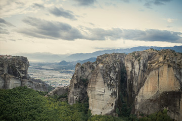 Fototapeta premium Landscape of monasteries of Meteora in Greece in Thessaly at the early morning. Cliffs of Meteora opposite a morning cloudy sky background