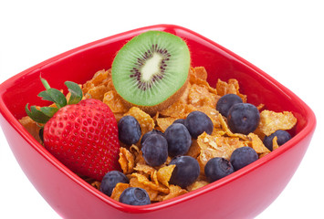 Cornflakes cereal with strawberries and blueberries