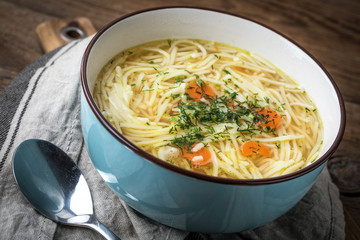 Broth - chicken soup in a blue bowl.
