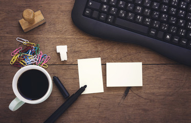 Fototapeta na wymiar arabic cup coffee and wooden stamp, white card, cinnamon stick,black pen,black keyboard