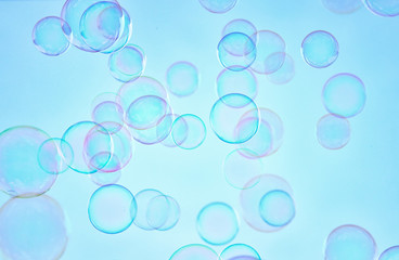 Soap bubbles floating in the air against soft clouds and sky. filtered image. selective focus.