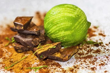 Lime and pieces of chocolate sprinkled with cinnamon.