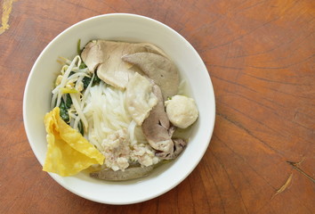 rice noodles topping slice pork and entrails in soup on bowl