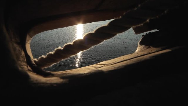 View of lake through the fairlead of a ship, ancient sailboat detail for documentaries and tv program