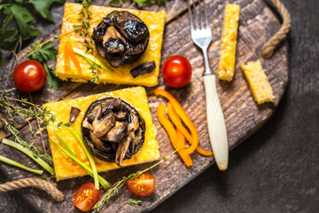 corn polenta with roasted mushrooms and eggplant, traditional Italian food with vegetables and thyme