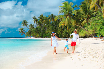 family with child playing on beach