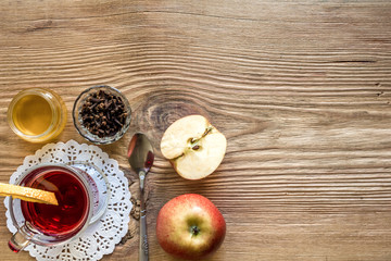 Mulled wine with spices on wooden background