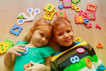 Fototapeta premium happy little girl and boy learn numbers and shapes