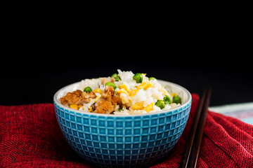 Homemade Chinese fried rice with vegetables and fried eggs