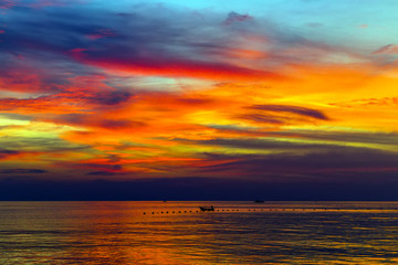 Fototapeta premium Tropical Sunset or Sunrise with reflection in water, colorful clouds