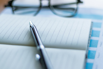 business hands checking a data paper.Focus on a pen