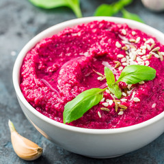 Beetroot pumpkin seed pesto on dark blue background. Selective focus, copy space. 