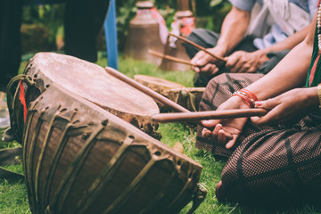 cropped shot of people playing leather drums with sticks in Nepal - obrazy, fototapety, plakaty