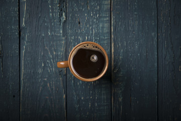 Fototapeta premium Coffee cup and beans on old kitchen table. Top view with copyspace for your text