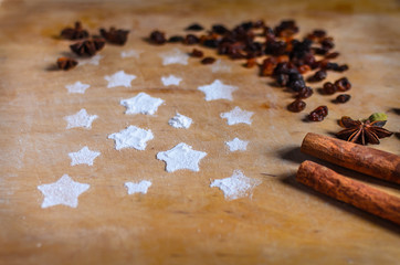 Spices on wooden cutting board. Christmas backing.