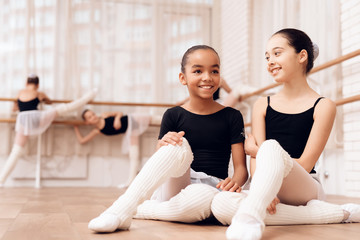 Young ballerinas rest during a break in the ballet classes.