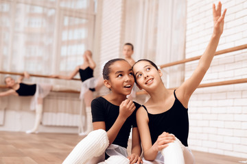 Young ballerinas rest during a break in the ballet classes.