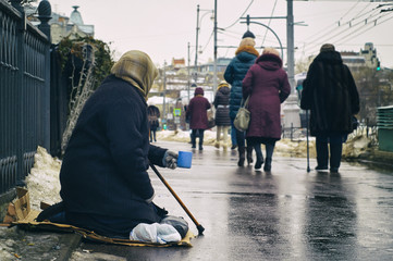 Female beggar asking for money on Moscow street in winter