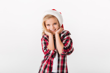 Portrait of a lovely little girl dressed in christmas hat
