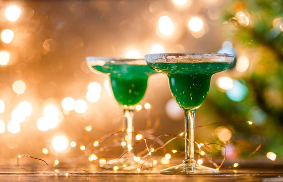 Christmas photo of two wine glasses with green cocktail